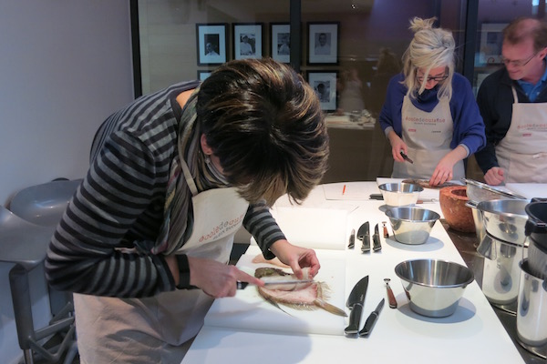 Filleting fish at Alain Ducasse Cooking School in Paris. Food Experiences In Paris