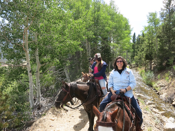 Diana enjoying a day of horseback riding at Rawah Ranch