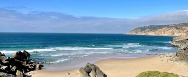 Saudade, Portuguese word meaning nostalgia or longing composed with yellow  colored stone letters over green sand Stock Photo - Alamy