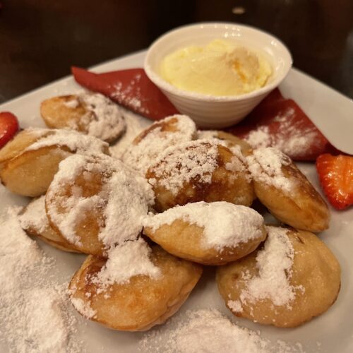 https://foodtravelist.com/wp-content/uploads/2023/07/Poffertjes-Mini-Pancakes-Dutch-500x500.jpeg